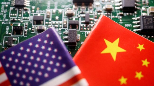FILE - Flags of the U.S. and China are displayed against the backdrop of a circuit board with semiconductor chips, in this illustration photo taken Feb. 17, 2023.
