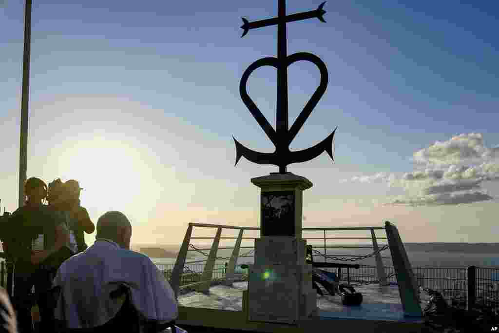 Pope Francis prays in front of the Memorial dedicated to sailors and migrants lost at sea during a moment of reflection with religious leaders, in Marseille, France.