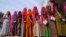FILE - Women stand in a queue to cast their votes in Chachiyawas village, near Ajmer, India, Nov. 25, 2023.