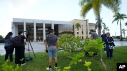 Journalists wait for WikiLeaks founder Julian Assange outside the United States courthouse where he is expected to enter a plea deal, in Saipan, Mariana Islands, June 26 2024.