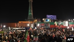 Supporters of Pakistan's former prime minister Imran Khan gather at a rally in Lahore early on March 26, 2023.