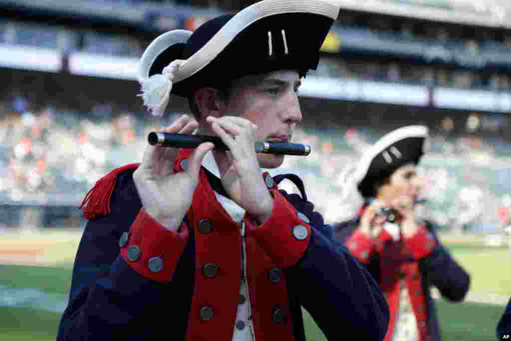 A member of the the Plymouth Fife and Drum Corps, from Plymouth, Mich., plays his fife while entertaining fans for Independence Day, before the Detroit Tigers' baseball game against the Oakland Athletics on July 4, 2023, in Detroit.