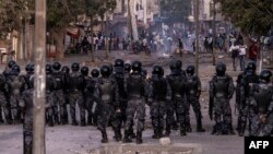 FILE - Senegalese Gendarmerie block a road after protests burned tires and blocked roads in Dakar, June 3, 2023. 