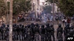 FILE - Senegalese Gendarmerie block a road after protests burned tires and blocked roads in Dakar, June 3, 2023. 