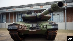 FILE - A Leopard 2 main battle tank is parking in front of a facility at the German forces Bundeswehr training area in Munster, Germany, Feb. 20, 2023. 