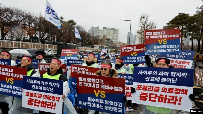 Doctors and Medical workers take part in a protest against a plan to admit more students to medical school, in front of the Presidential Office in Seoul, South Korea, Feb. 21, 2024.