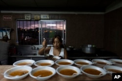 Volunteer Edith Garcia prepares soup to serve migrants, mostly Mexican nationals deported from the U.S., at the San Juan Bosco migrant shelter in Nogales, Mexico, June 25, 2024.