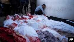 Palestinians mourn relatives killed in the Israeli bombardment of the Gaza Strip at a hospital morgue in Rafah, Feb. 12, 2024. The Israeli military said early Monday that it had rescued the two hostages from captivity in the Gaza Strip.