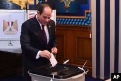 In this photo provided by Egypt's presidency media office, Egyptian President Abdel-Fattah el-Sissi, casts his vote for the presidential elections at a polling station, in Cairo, Egypt, Dec. 10, 2023.