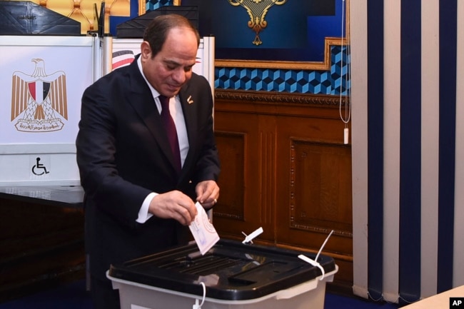 In this photo provided by Egypt's presidency media office, Egyptian President Abdel Fattah el-Sissi, casts his vote for the presidential elections at a polling station, in Cairo, Egypt, Dec. 10, 2023.