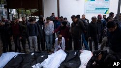 Palestinians mourn relatives killed in the Israeli bombardment of the Gaza Strip at a hospital morgue in Rafah, Feb. 12, 2024. 