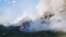 FILE — Smoke rises above the southeast perimeter of the Paskwa fire near Fox Lake, Alberta, Canada, May 16, 2023. Seventeen wildfires have broken out in Alberta in 2024; 52 have been burning since last year. (Alberta Wildfire/Handout via Reuters) 