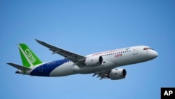 A Chinese COMAC C919 aircraft flies during first day of the Singapore Airshow, Feb. 20, 2024. The single-aisle jet drew hundreds of orders at the show, but analysts say it still has a long way to go before it can compete with aircraft from market leaders.