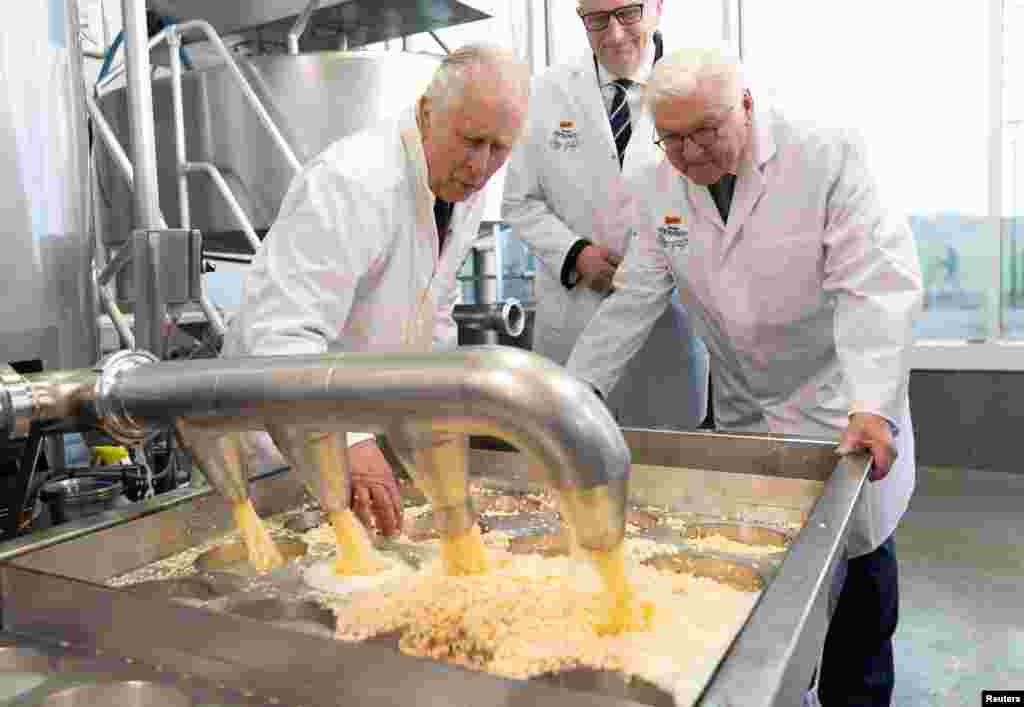 King Charles III has a go at cheese making during a visit to an organic farm in Brandenburg, Germany.