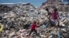 Palestinian children sort through trash at a landfill in Nuseirat refugee camp, Gaza Strip, June 20, 2024. 