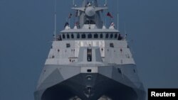 Members of Taiwan&#39;s Navy onboard a Tuo Chiang-class corvette participate in a drill on the waters near a military base in Kaohsiung.