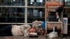 A homeless man sleeps near his belongings at the Jorge Newbery international airport, commonly known as Aeroparque, in Buenos Aires, Argentina, April 6, 2023.