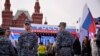 FILE - Russian National Guard (Rosgvardiya) servicemen keep watch as people gather for a concert dedicated to the first anniversary of the annexation of four regions of Ukraine Russian troops control, at Red Square in central Moscow, Sept. 29, 2023.