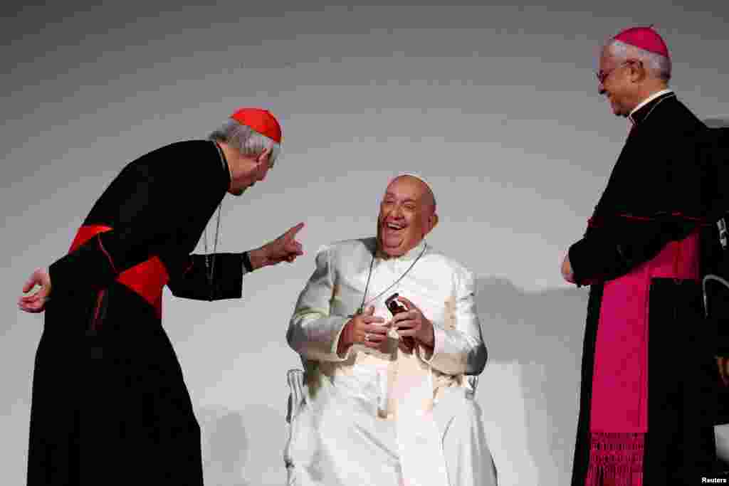 Pope Francis with cardinal Matteo Zuppi and Italian archbishop of Catania Luigi Renna standing next to him, attends the 50th Social Week of Catholics at the &quot;Generali Convention Center&quot; in Trieste, Italy.