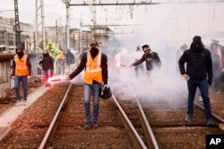 Railway workers demonstrate on the tracks at the Gare de Lyon train station, Tuesday, March 28, 2023 in Paris. A new round of strikes and demonstrations is planned against the unpopular pension reforms that, most notably, push the legal retirement age from 62 to 64.