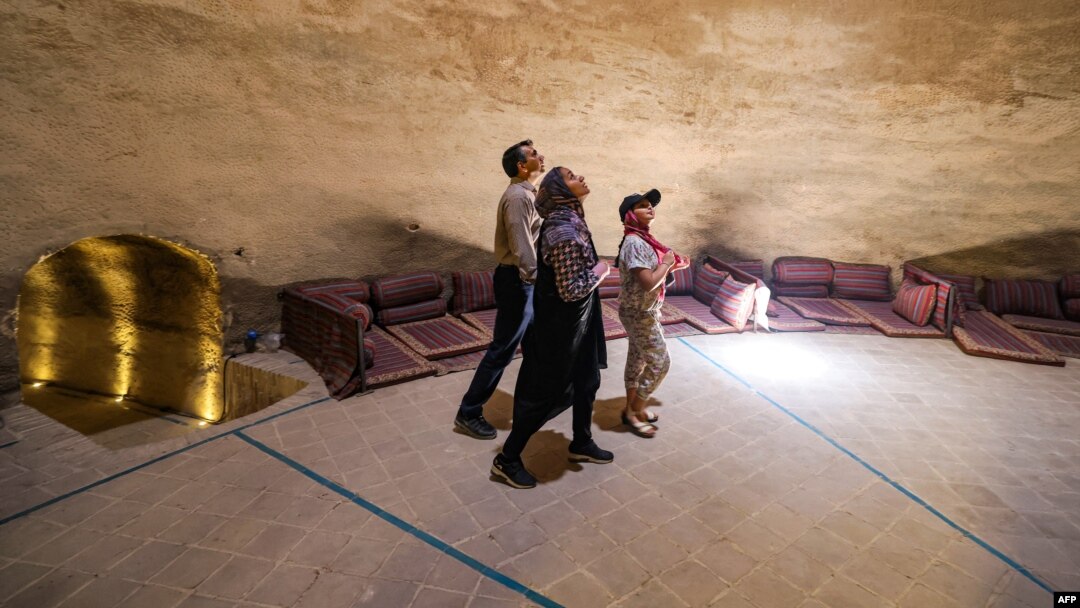 People visit the Safavid-era (1501-1736) Bagh Gandom Ab-Anbar (cistern) in Iran's central city of Yazd on July 3, 2023.