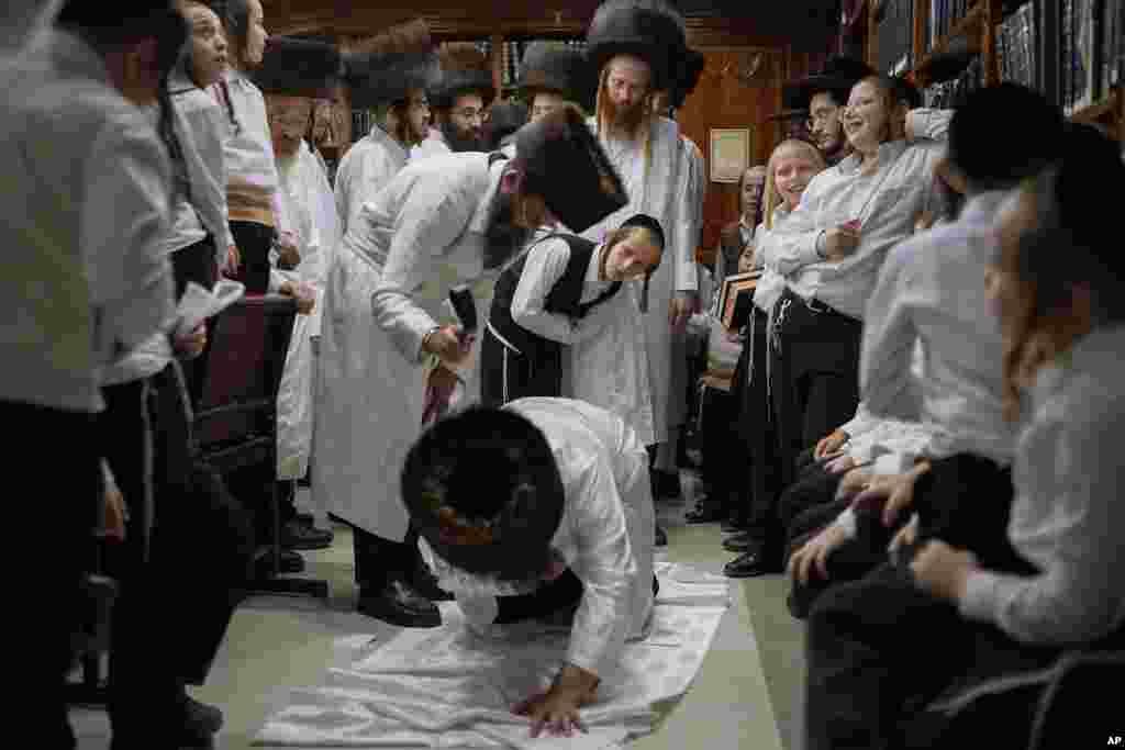 An ultra-Orthodox Jewish man whips a member of his Hasidic dynasty with a leather strap as a symbolic punishment for his sins last year, during the traditional Malkot (whipping in Hebrew) ceremony in the city of Beit Shemesh, Israel.