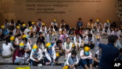 FILE - A group of students listen to their tour guide at the Museum of Terracotta Warriors and Horses of Emperor Qin Shihuang in Xi'an in northwestern China's Shaanxi Province, July 16, 2023.