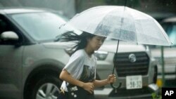 A person walks in the rain in Tokyo, Aug. 30, 2024. Tropical Storm Shanshan brought torrential rain to parts of Japan over the weekend.