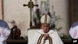 Pope Francis prays in front of the altar in St. Peter's Square at the Vatican during the Easter Sunday Mass, April 9, 2023.