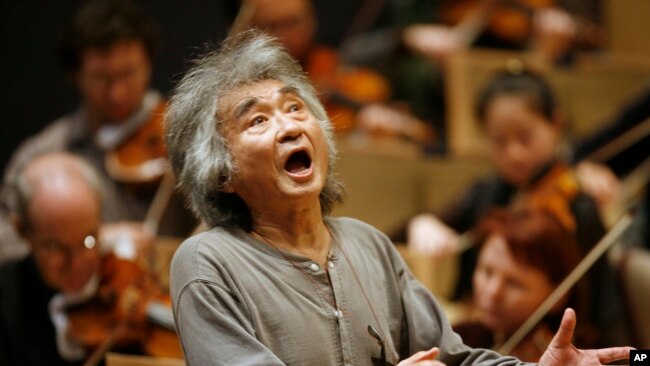 FILE - Former Director of the Boston Symphony Orchestra Seiji Ozawa conducts the orchestra during a rehearsal of Berlioz's
