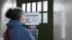 A woman enters a polling station during the 'Berlin 2030 Climate Neutral' referendum in Berlin, Germany, March 26, 2023. 