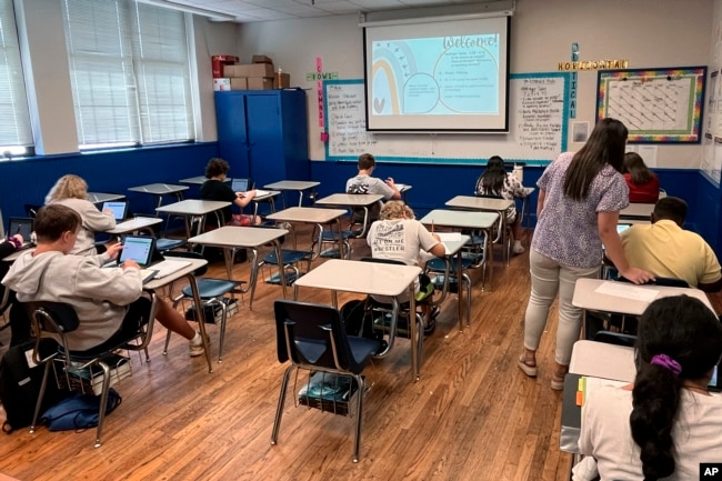 Math teacher Cheyenne Crider helps a seventh-grade student with a math problem at Piedmont Middle School in Piedmont, Ala., on Thursday, Aug. 31, 2023. (Trisha Powell Crain/AL.com via AP)