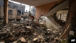 A Palestinian checks the destruction after Israeli strikes on the Gaza Strip in Khan Younis, Nov. 3, 2023.