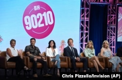 FILE - Gabrielle Carteris, from left, Brian Austin Green, Shannen Doherty, Ian Ziering, Jennie Garth and Tori Spelling participate in Fox's "BH90210" panel at the Television Critics Association Summer Press Tour, Aug. 7, 2019, in Beverly Hills, Calif.