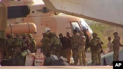 FILE - This undated photograph provided by the French military shows Russian mercenaries boarding a helicopter in northern Mali. (French Army via AP)