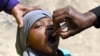 FILE - A community health worker administers a polio vaccine during the polio immunization campaign in Kiamako, Nairobi, Kenya, July 19, 2021.