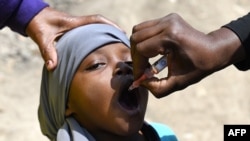 FILE - A community health worker administers a polio vaccine during the polio immunization campaign in Kiamako, Nairobi, Kenya, July 19, 2021.