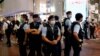 FILE - Police stand guard at the site where a man allegedly stabbed a policeman then stabbed himself in the chest with the knife and died on the anniversary of the city's return to Chinese rule, at Causeway Bay in Hong Kong, July 2, 2021. 