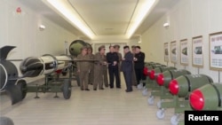 A screen grab shows North Korean leader Kim Jong Un inspecting nuclear warheads at an undisclosed location in this undated still image used in a video.