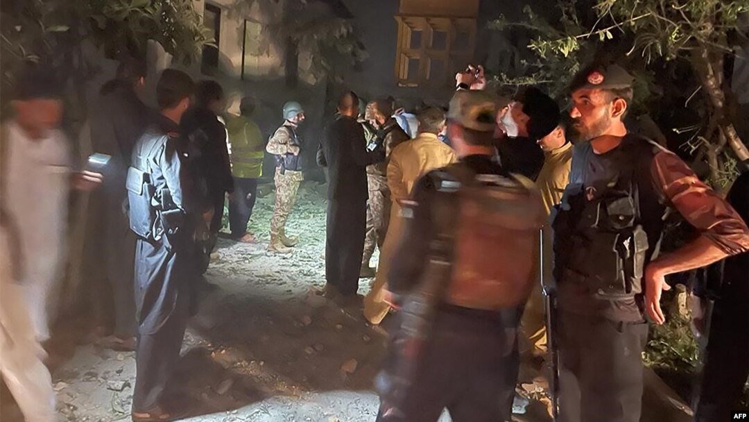 Petugas keamanan berkumpul di lokasi setelah beberapa ledakan yang disebabkan oleh kebakaran di gudang amunisi di kantor polisi Pakistan di Kabal, di Lembah Swat, pada 24 April 2023. (Foto: AFP)