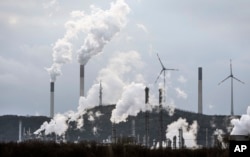 FILE - The industrial backdrop of a BP refinery and a Uniper coal-fired power plant is seen in Gelsenkirchen, Germany, March 6, 2023. (AP Photo/Martin Meissner, File)