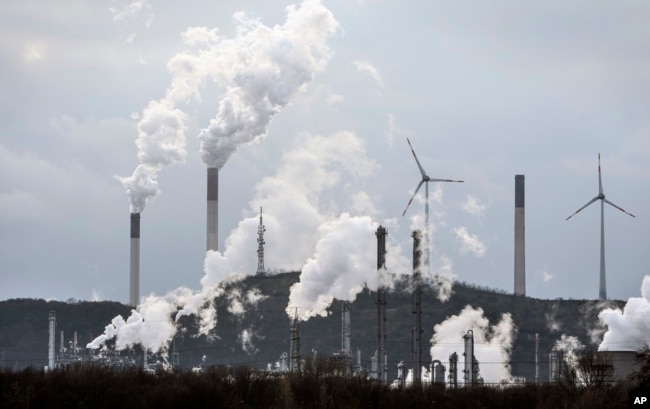 FILE - The industrial backｄrop of a BP refinery and a Uniper coal-fired power plant is seen in Gelsenkirchen, Germany, March 6, 2023. (AP Photo/Martin Meissner, File)