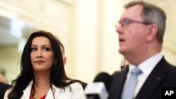 Emma Little-Pengelly watches Jeffrey Donaldson, leader of the DUP, speaking to the media at Stormont Parliament Buildings in Belfast, Northern Ireland, Feb. 3, 2024.