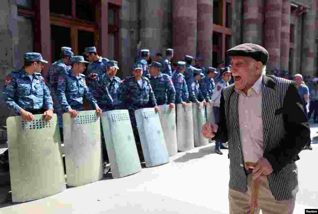 A protester reacts during a gathering outside the government building following the launch of a military operation by Azerbaijani forces in the region of Nagorno-Karabakh, in Yerevan, Armenia.