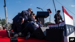 FILE - Republican presidential candidate former President Donald Trump is shielded by U.S. Secret Service agents during a shooting at a campaign rally in Butler, Pennsylvania, July 13, 2024.