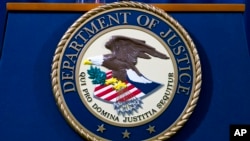 FILE - The U.S. Department of Justice seal in Washington, Nov. 28, 2018. The Justice Department said on Sept. 21, 2023, that a contractor for the U.S. government who is originally from Ethiopia was arrested on espionage charges.