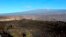 FILE - Hawaii's Mauna Loa volcano, background, towers over the summit crater of Kilauea volcano in Hawaii Volcanoes National Park on the Big Island on April 25, 2019.