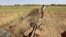 FILE - A farmer ploughs a field with his tractor in Shendi, some 190 kilometers from Khartoum, Sudan, Oct. 5, 2023.