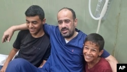 Mohammed Abu Selmia, direktur rumah sakit utama Gaza, yang ditahan oleh pasukan Israel, duduk bersama keluarganya setelah dibebaskan, bersama tahanan lainnya, di sebuah rumah sakit di Khan Younis, Jalur Gaza, 1 Juli 2024.