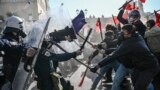 FILE - Students clash with riot police in front of the Greek Parliament during a demonstration against the government's plans for private universities, in Athens, Feb. 1, 2024. (Photo by Angelos TZORTZINIS / AFP)
